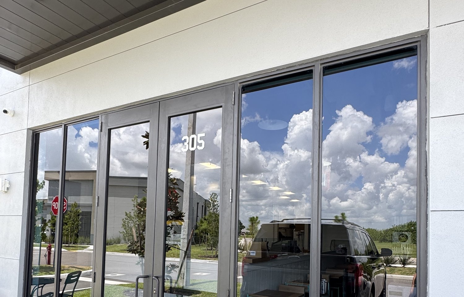 Clean commercial storefront glass and entry doors at a Cape Coral plaza